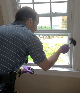 Forensics Officer Investigating Around a Window