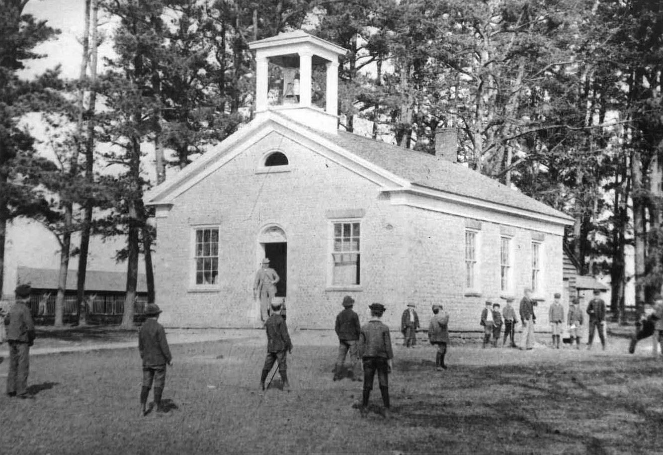 Cobblestone Schoolhouse - In this 1890s or early 1900s view of the school to have survived is an action shot of the boys playing what appears to be a game of baseball, while the girls would likely have been observers on the sidelines. Note behind the school stood the wood shed with one of the “back houses” to its rear.